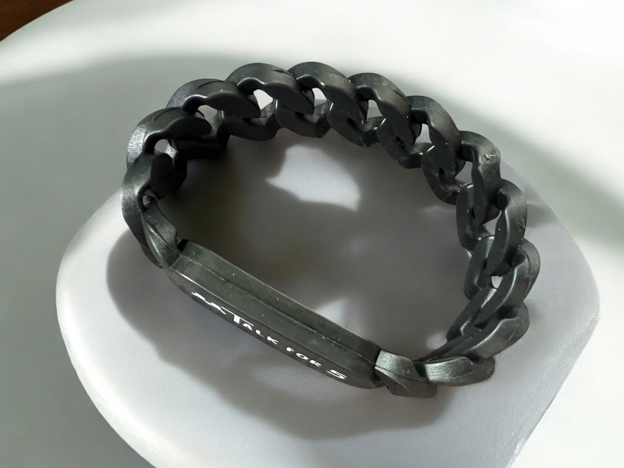 Black chain link bracelet with 'Talk for 5' tag on a white surface, perfect for corporates, organizations and schools