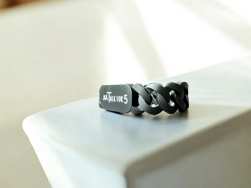 Black chain bracelet with 'Talk for 5' tag on a white surface, perfect for corporates, organizations and schools